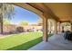 The home features a well-maintained backyard with artificial turf, covered patio, and desert landscaping at 12690 S 184Th Ave, Goodyear, AZ 85338