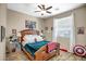 Comfortable bedroom featuring a ceiling fan, window, and themed decor, perfect for a space at 12690 S 184Th Ave, Goodyear, AZ 85338