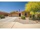 Charming single-story home with desert landscaping, a two-car garage, and a vibrant yellow tree at 12690 S 184Th Ave, Goodyear, AZ 85338