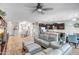 Spacious living room featuring tile floors, a comfortable seating area, and an open layout to the kitchen at 12690 S 184Th Ave, Goodyear, AZ 85338