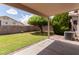 Charming backyard with well-maintained lawn, mature tree, and shaded patio area at 137 W Del Rio St, Gilbert, AZ 85233