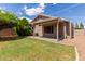 Backyard features a covered patio with a grassy area and gravel landscaping at 137 W Del Rio St, Gilbert, AZ 85233