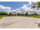 Outdoor basketball court in a park with mature trees, lush grass, and blue skies at 137 W Del Rio St, Gilbert, AZ 85233