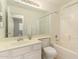 Bright bathroom featuring a vanity, toilet, and shower-tub combo with ample lighting at 137 W Del Rio St, Gilbert, AZ 85233