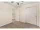 Carpeted bedroom with ceiling fan, access to ensuite, and a closet providing ample storage at 137 W Del Rio St, Gilbert, AZ 85233