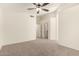 Large bedroom with neutral walls and carpet, showing passage way to bathroom and closet space at 137 W Del Rio St, Gilbert, AZ 85233