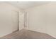 Carpeted bedroom showcasing closet and entry doors, filled with ample natural light at 137 W Del Rio St, Gilbert, AZ 85233