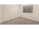 Cozy bedroom featuring a window for natural light and plush carpet flooring at 137 W Del Rio St, Gilbert, AZ 85233
