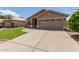 Inviting one-story home with a lush green lawn and extended driveway at 137 W Del Rio St, Gilbert, AZ 85233