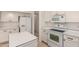 Modern kitchen equipped with white appliances, sleek countertops, and ample cabinet space for storage at 137 W Del Rio St, Gilbert, AZ 85233