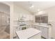 Bright kitchen featuring white cabinets, stainless steel appliances, and an island with lots of counter space at 137 W Del Rio St, Gilbert, AZ 85233