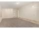 Open-concept living room with carpet, tile flooring at entry, and an arched doorway at 137 W Del Rio St, Gilbert, AZ 85233