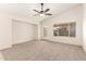 Cozy living room with vaulted ceilings, carpeted floors, and a glass panel patio door at 137 W Del Rio St, Gilbert, AZ 85233