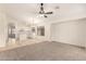 Open-concept living area with a ceiling fan and adjacent bright kitchen, perfect for entertaining at 137 W Del Rio St, Gilbert, AZ 85233