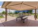 Covered picnic area with tables and benches next to a playground at 137 W Del Rio St, Gilbert, AZ 85233