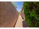 The side yard features a gravel path with landscaping and a gate at 137 W Del Rio St, Gilbert, AZ 85233
