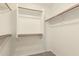 Bright walk-in closet featuring shelving and wood closet rods providing ample storage space at 137 W Del Rio St, Gilbert, AZ 85233