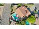 Aerial view of a home featuring a red tile roof, swimming pool, patio area, and green landscaping at 14034 S 34Th Pl, Phoenix, AZ 85044