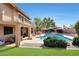 Spacious backyard with a pool, patio, seating area, and lush, green landscaping at 14034 S 34Th Pl, Phoenix, AZ 85044