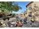 Private backyard with a fire pit, lush landscaping, outdoor seating, and a built-in barbecue area at 14034 S 34Th Pl, Phoenix, AZ 85044