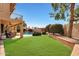 Spacious backyard featuring a well-maintained lawn, pool, patio and lush landscaping at 14034 S 34Th Pl, Phoenix, AZ 85044