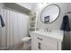 Clean bathroom with a white vanity, modern fixtures, and a shower with a decorative curtain at 14034 S 34Th Pl, Phoenix, AZ 85044