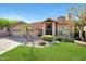 Charming home featuring a three-car garage, tile roof, lush green lawn, and desert landscaping at 14034 S 34Th Pl, Phoenix, AZ 85044