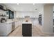 Bright kitchen with white cabinets, stainless steel appliances, a gray island, and decorative backsplash at 14034 S 34Th Pl, Phoenix, AZ 85044