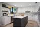 Updated kitchen featuring an island, white countertops and cabinetry, stainless steel appliances, and a decorative backsplash at 14034 S 34Th Pl, Phoenix, AZ 85044