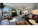 Open living room with a fireplace, comfortable seating, and a seamless flow to the kitchen and dining area at 14034 S 34Th Pl, Phoenix, AZ 85044
