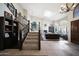 Open-concept living room and foyer featuring a grand staircase, hardwood floors, and a cozy fireplace at 14034 S 34Th Pl, Phoenix, AZ 85044