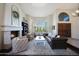 Bright living room featuring large windows, hardwood floors, a cozy fireplace, and comfortable seating at 14034 S 34Th Pl, Phoenix, AZ 85044