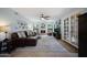 Comfortable living room with a fireplace, large leather sofa, plush carpet, and natural light at 14034 S 34Th Pl, Phoenix, AZ 85044