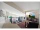 Open loft area with railing overlooking the downstairs, featuring a television and comfortable seating at 14034 S 34Th Pl, Phoenix, AZ 85044