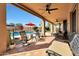 Covered patio with ceiling fans, comfortable seating, and views of the pool and landscaped backyard at 14034 S 34Th Pl, Phoenix, AZ 85044