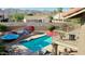 Backyard pool area with lounge chairs, umbrellas, barbecue, desert landscaping, and mountain views at 14034 S 34Th Pl, Phoenix, AZ 85044