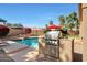 Outdoor barbecue area next to the pool with built-in grill and stainless steel storage at 14034 S 34Th Pl, Phoenix, AZ 85044