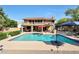 Backyard pool and patio with outdoor kitchen, dining, lounge seating, and beautiful desert landscaping at 14034 S 34Th Pl, Phoenix, AZ 85044