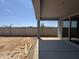 A covered patio and block wall surround this desert landscaped backyard space at 15785 W Cheryl Dr, Waddell, AZ 85355