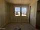 Bedroom with dual windows and a closet area awaiting final touches at 15785 W Cheryl Dr, Waddell, AZ 85355