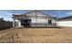 Rear exterior view of new home under construction in a partially-built community at 15785 W Cheryl Dr, Waddell, AZ 85355