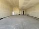 Spacious garage with concrete floor and white walls; lots of potential for storage and parking at 15785 W Cheryl Dr, Waddell, AZ 85355
