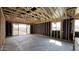 Bright, unfinished living room featuring slider glass door and exposed wood beams at 15785 W Cheryl Dr, Waddell, AZ 85355