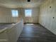 View of large living room with two windows and tile flooring at 15785 W Cheryl Dr, Waddell, AZ 85355