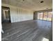 Large living room showcases tile flooring and sliding glass door access to the backyard at 15785 W Cheryl Dr, Waddell, AZ 85355