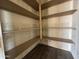 Walk-in pantry offers ample shelving for optimal kitchen storage at 15785 W Cheryl Dr, Waddell, AZ 85355
