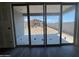 View from inside looking out at the backyard and block wall, seen through sliding glass doors at 15785 W Cheryl Dr, Waddell, AZ 85355