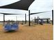 Modern playground equipped with slides, climbing structures, and shade canopies for fun and safe play at 15785 W Cheryl Dr, Waddell, AZ 85355