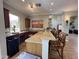 Entertaining bar area with a long granite countertop, dark wood cabinetry, a wine cooler, and comfortable seating at 16013 S Desert Foothills Pkwy # 2056, Phoenix, AZ 85048