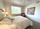Cozy bedroom featuring a large bed with decorative pillows and a scenic window view at 16013 S Desert Foothills Pkwy # 2056, Phoenix, AZ 85048